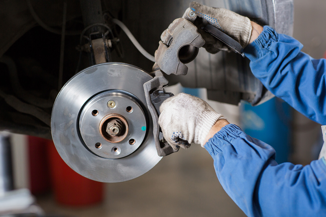 Jeep service technician working on a brake rotor