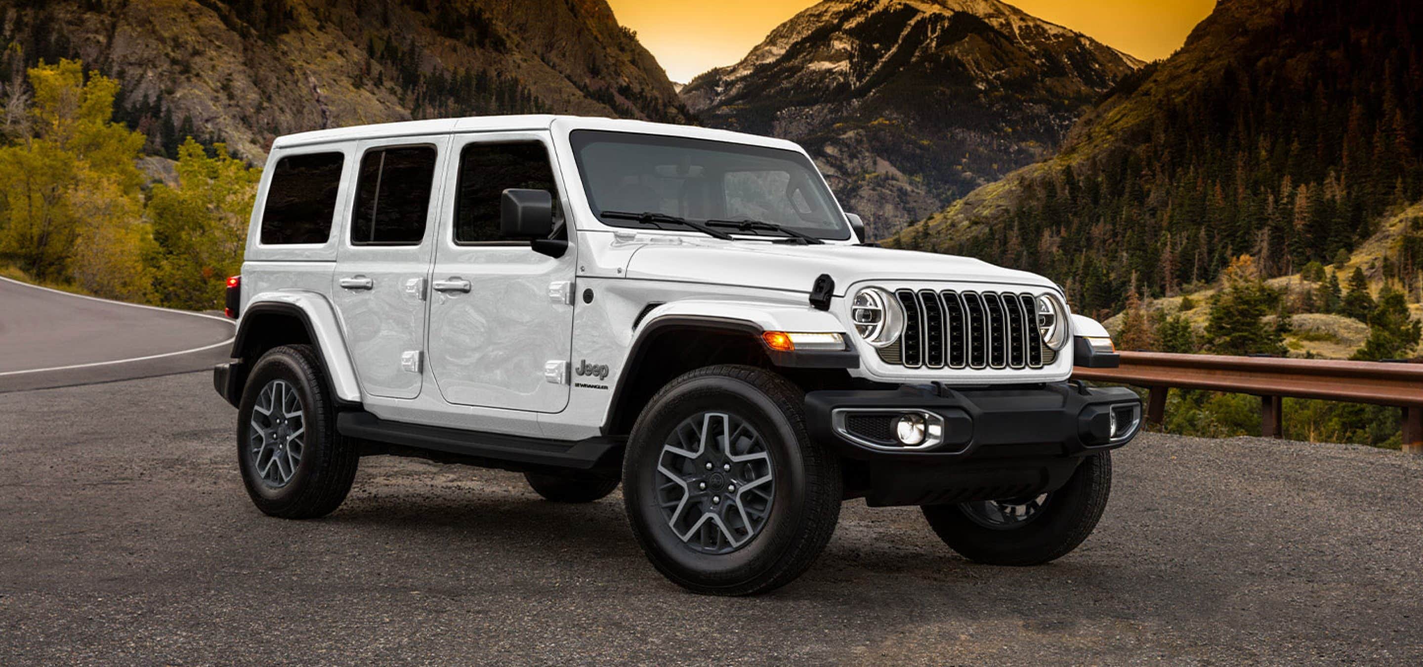 White 2025 Jeep Wrangler with mountains in the back