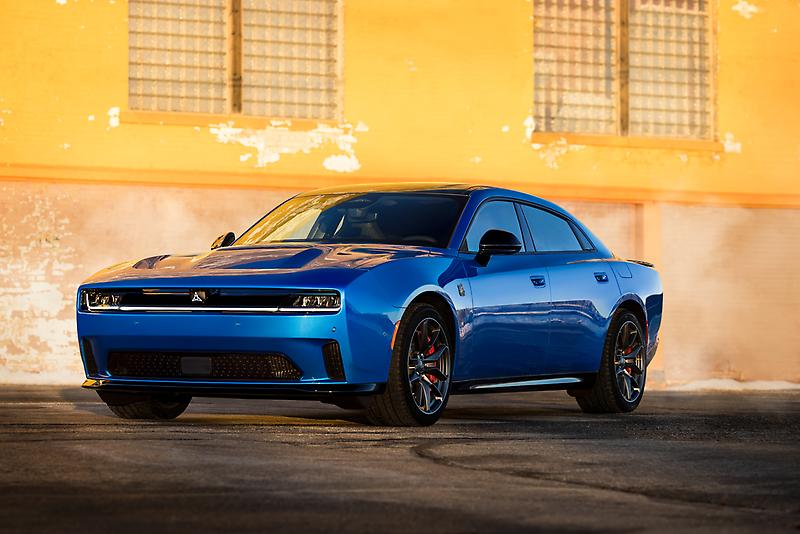blue dodge charger parked in front of yellow building