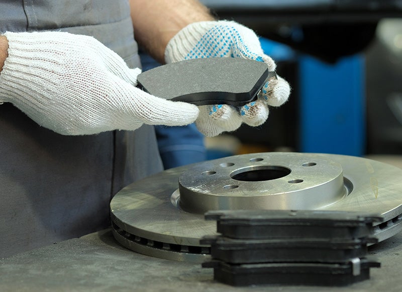Technician fixing car brakes